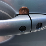 Coin on a car door handle — what it means