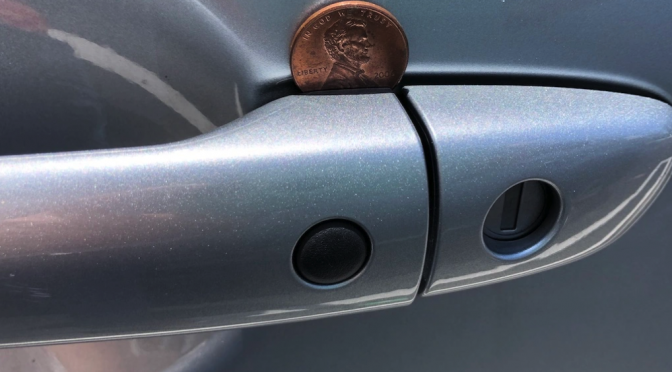 Coin on a car door handle — what it means